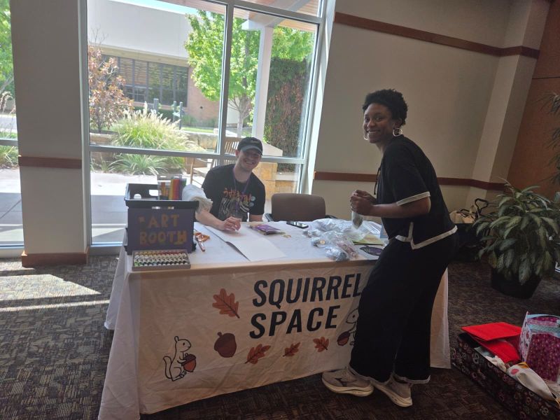 Art and community activity table at the 2026 Bash